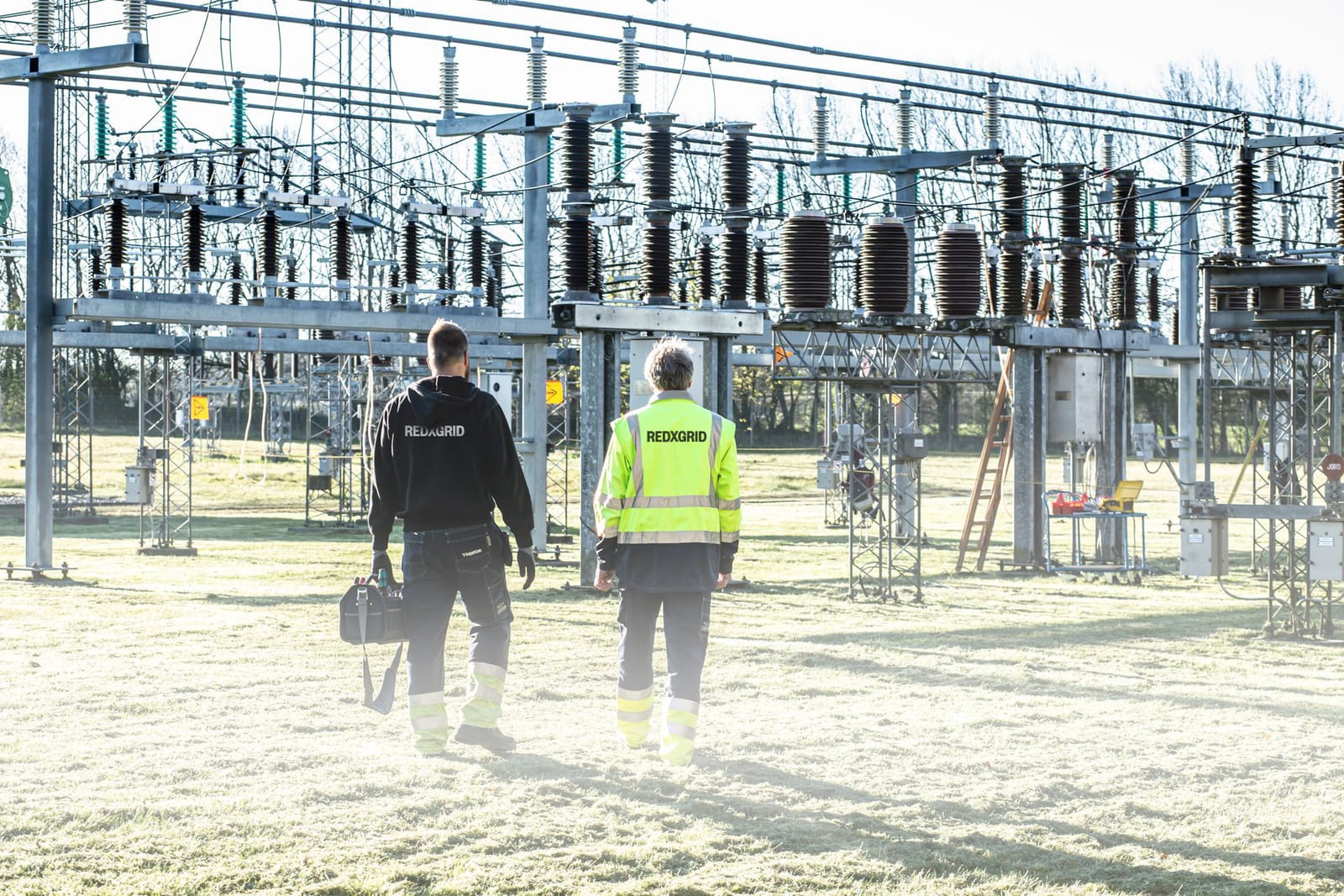 Engineers walking a substation during an inspection