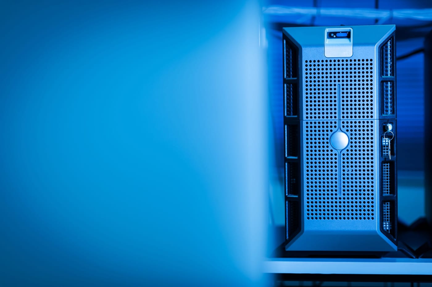 Rows of data-centre racks lit in blue