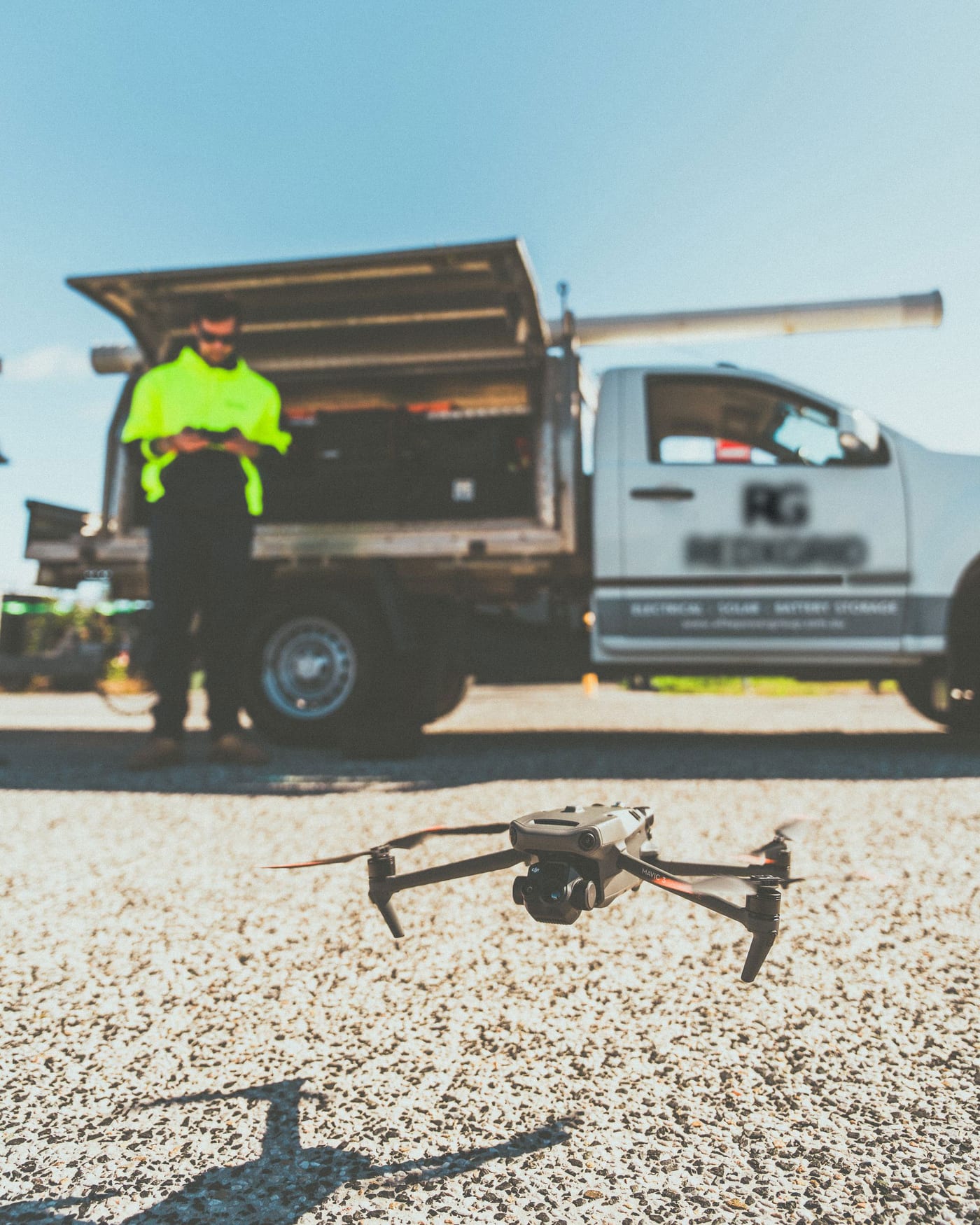 Technician launching an inspection drone on site