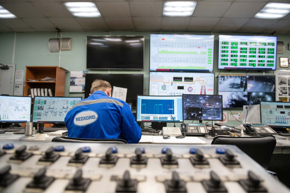 Operator monitoring screens in a grid control room